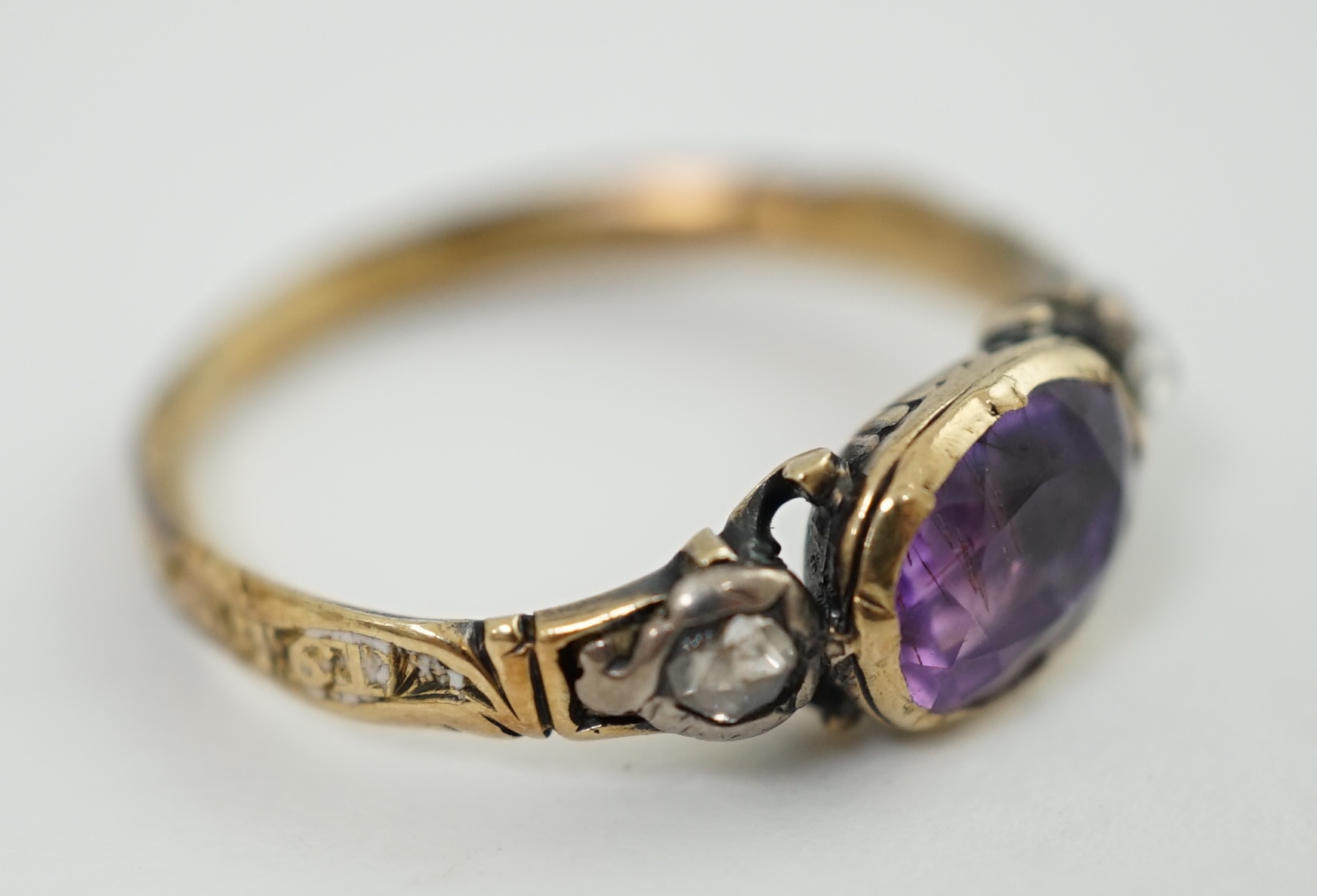 A George III gold, single stone foil backed amethyst and two stone rose cut diamond set memorial ring